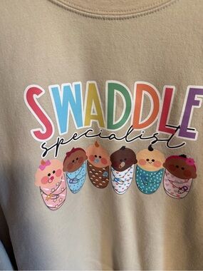 Ladies Beige "Swaddle Specialist" Graphic Tee